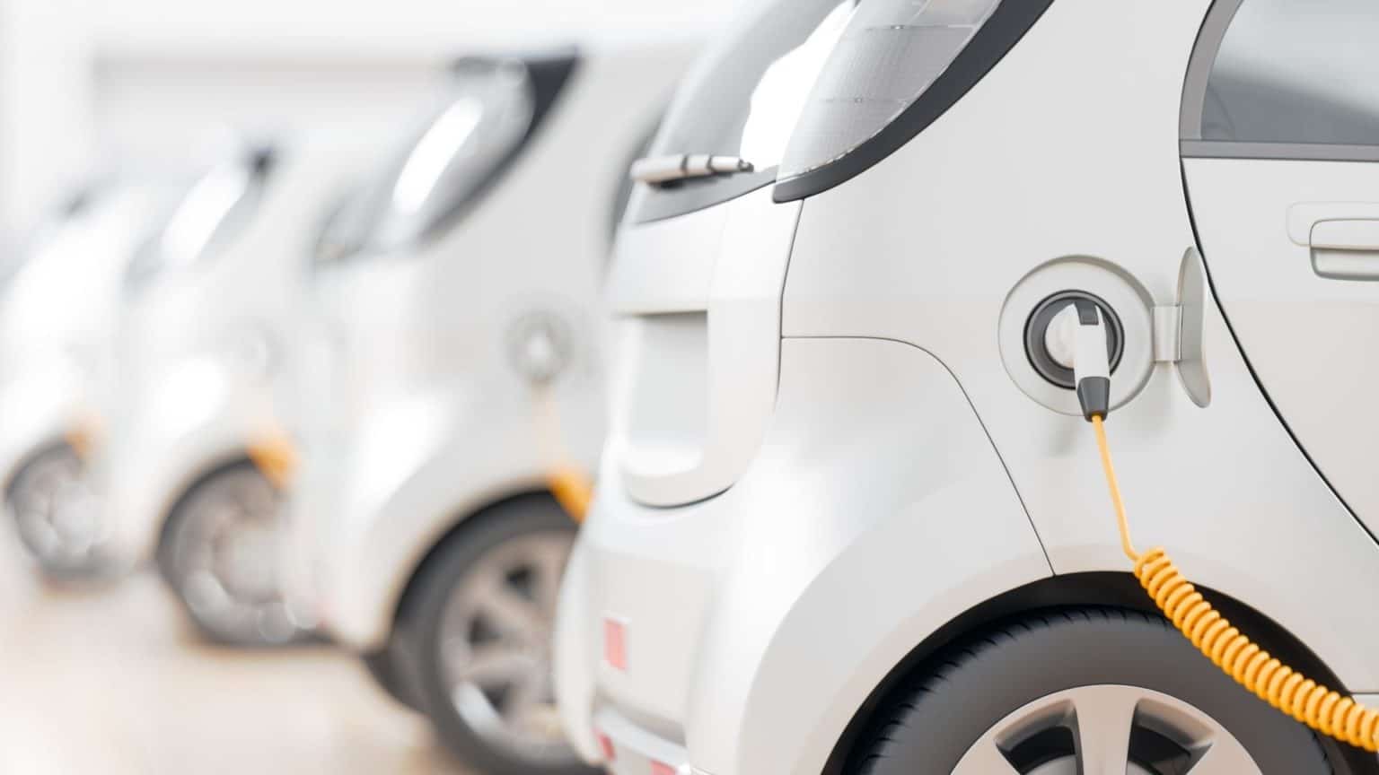 Row of electric cars parked together.
